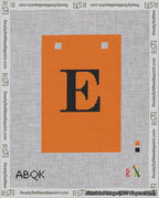 A taped needlepoint canvas with the design: Banner 18 mesh count Squared E Black on Orange.