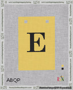 A taped needlepoint canvas with the design: Banner 18 mesh count Squared E Black on Yellow.
