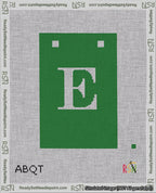 A taped needlepoint canvas with the design: Banner 18 mesh count Squared E White on Green.