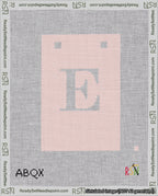 A taped needlepoint canvas with the design: Banner 18 mesh count Squared E White on Pink.