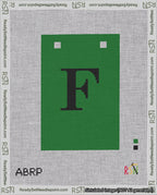 A taped needlepoint canvas with the design: Banner 18 mesh count Squared F Black on Green.