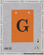 A taped needlepoint canvas with the design: Banner 18 mesh count Squared G Black on Orange.