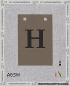 A taped needlepoint canvas with the design: Banner 18 mesh count Squared H Black on Brown.