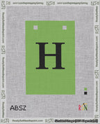A taped needlepoint canvas with the design: Banner 18 mesh count Squared H Black on Light Green.