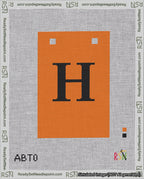 A taped needlepoint canvas with the design: Banner 18 mesh count Squared H Black on Orange.