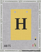 A taped needlepoint canvas with the design: Banner 18 mesh count Squared H Black on Yellow.