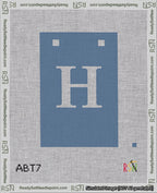 A taped needlepoint canvas with the design: Banner 18 mesh count Squared H White on Blue.