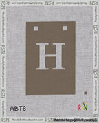 A taped needlepoint canvas with the design: Banner 18 mesh count Squared H White on Brown.