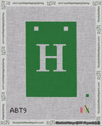A taped needlepoint canvas with the design: Banner 18 mesh count Squared H White on Green.