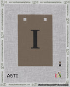 A taped needlepoint canvas with the design: Banner 18 mesh count Squared I Black on Brown.
