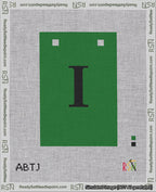 A taped needlepoint canvas with the design: Banner 18 mesh count Squared I Black on Green.