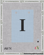 A taped needlepoint canvas with the design: Banner 18 mesh count Squared I Black on Light Blue.