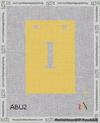 A taped needlepoint canvas with the design: Banner 18 mesh count Squared I White on Yellow.