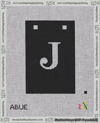 A taped needlepoint canvas with the design: Banner 18 mesh count Squared J White on Black.