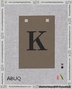 A taped needlepoint canvas with the design: Banner 18 mesh count Squared K Black on Brown.