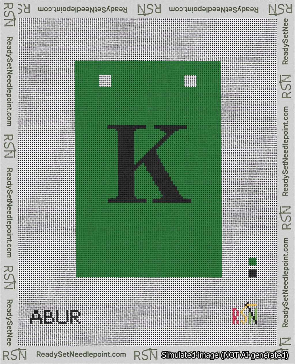 A taped needlepoint canvas with the design: Banner 18 mesh count Squared K Black on Green.