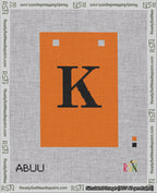 A taped needlepoint canvas with the design: Banner 18 mesh count Squared K Black on Orange.