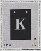 A taped needlepoint canvas with the design: Banner 18 mesh count Squared K White on Black.
