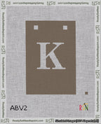 A taped needlepoint canvas with the design: Banner 18 mesh count Squared K White on Brown.