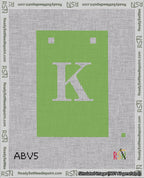 A taped needlepoint canvas with the design: Banner 18 mesh count Squared K White on Light Green.