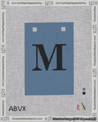 A taped needlepoint canvas with the design: Banner 18 mesh count Squared M Black on Blue.