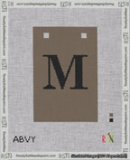 A taped needlepoint canvas with the design: Banner 18 mesh count Squared M Black on Brown.