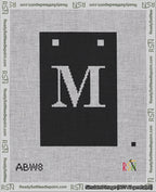 A taped needlepoint canvas with the design: Banner 18 mesh count Squared M White on Black.