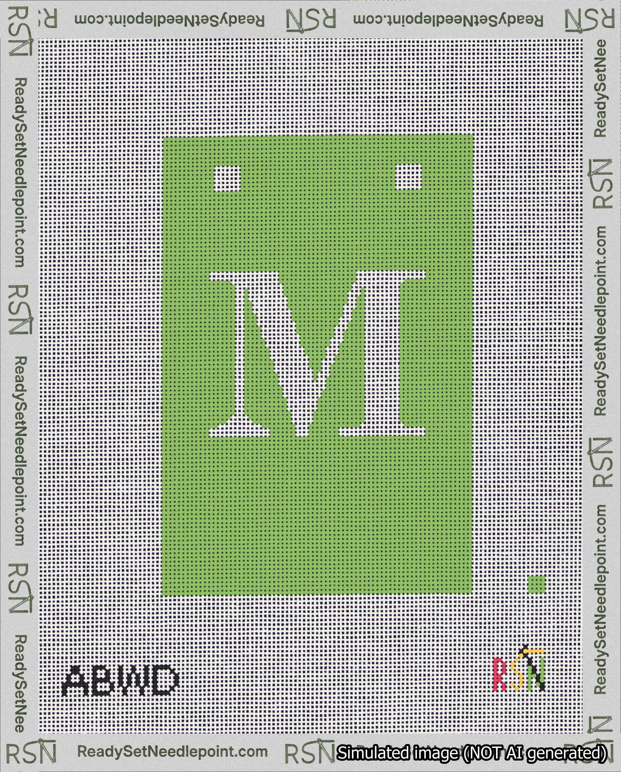 A taped needlepoint canvas with the design: Banner 18 mesh count Squared M White on Light Green.