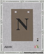 A taped needlepoint canvas with the design: Banner 18 mesh count Squared N Black on Brown.