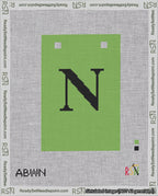 A taped needlepoint canvas with the design: Banner 18 mesh count Squared N Black on Light Green.
