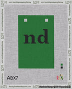 A taped needlepoint canvas with the design: Banner 18 mesh count Squared nd Black on Green.
