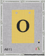 A taped needlepoint canvas with the design: Banner 18 mesh count Squared O Black on Yellow.