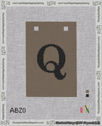 A taped needlepoint canvas with the design: Banner 18 mesh count Squared Q Black on Brown.