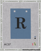 A taped needlepoint canvas with the design: Banner 18 mesh count Squared R Black on Blue.