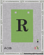 A taped needlepoint canvas with the design: Banner 18 mesh count Squared R Black on Light Green.