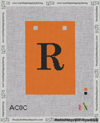 A taped needlepoint canvas with the design: Banner 18 mesh count Squared R Black on Orange.