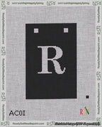 A taped needlepoint canvas with the design: Banner 18 mesh count Squared R White on Black.