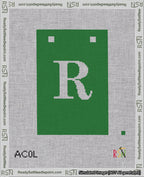 A taped needlepoint canvas with the design: Banner 18 mesh count Squared R White on Green.