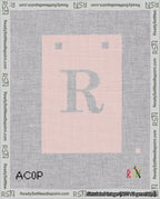 A taped needlepoint canvas with the design: Banner 18 mesh count Squared R White on Pink.