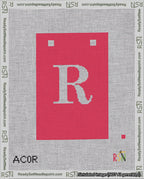 A taped needlepoint canvas with the design: Banner 18 mesh count Squared R White on Red.