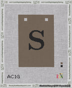 A taped needlepoint canvas with the design: Banner 18 mesh count Squared S Black on Brown.