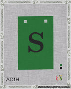 A taped needlepoint canvas with the design: Banner 18 mesh count Squared S Black on Green.