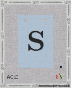 A taped needlepoint canvas with the design: Banner 18 mesh count Squared S Black on Light Blue.