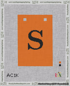 A taped needlepoint canvas with the design: Banner 18 mesh count Squared S Black on Orange.