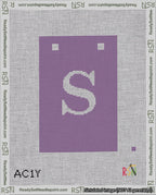 A taped needlepoint canvas with the design: Banner 18 mesh count Squared S White on Purple.
