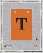 A taped needlepoint canvas with the design: Banner 18 mesh count Squared T Black on Orange.