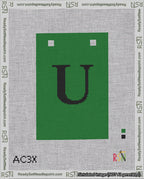 A taped needlepoint canvas with the design: Banner 18 mesh count Squared U Black on Green.