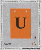 A taped needlepoint canvas with the design: Banner 18 mesh count Squared U Black on Orange.