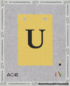 A taped needlepoint canvas with the design: Banner 18 mesh count Squared U Black on Yellow.