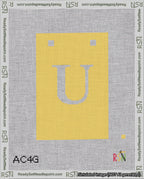 A taped needlepoint canvas with the design: Banner 18 mesh count Squared U White on Yellow.